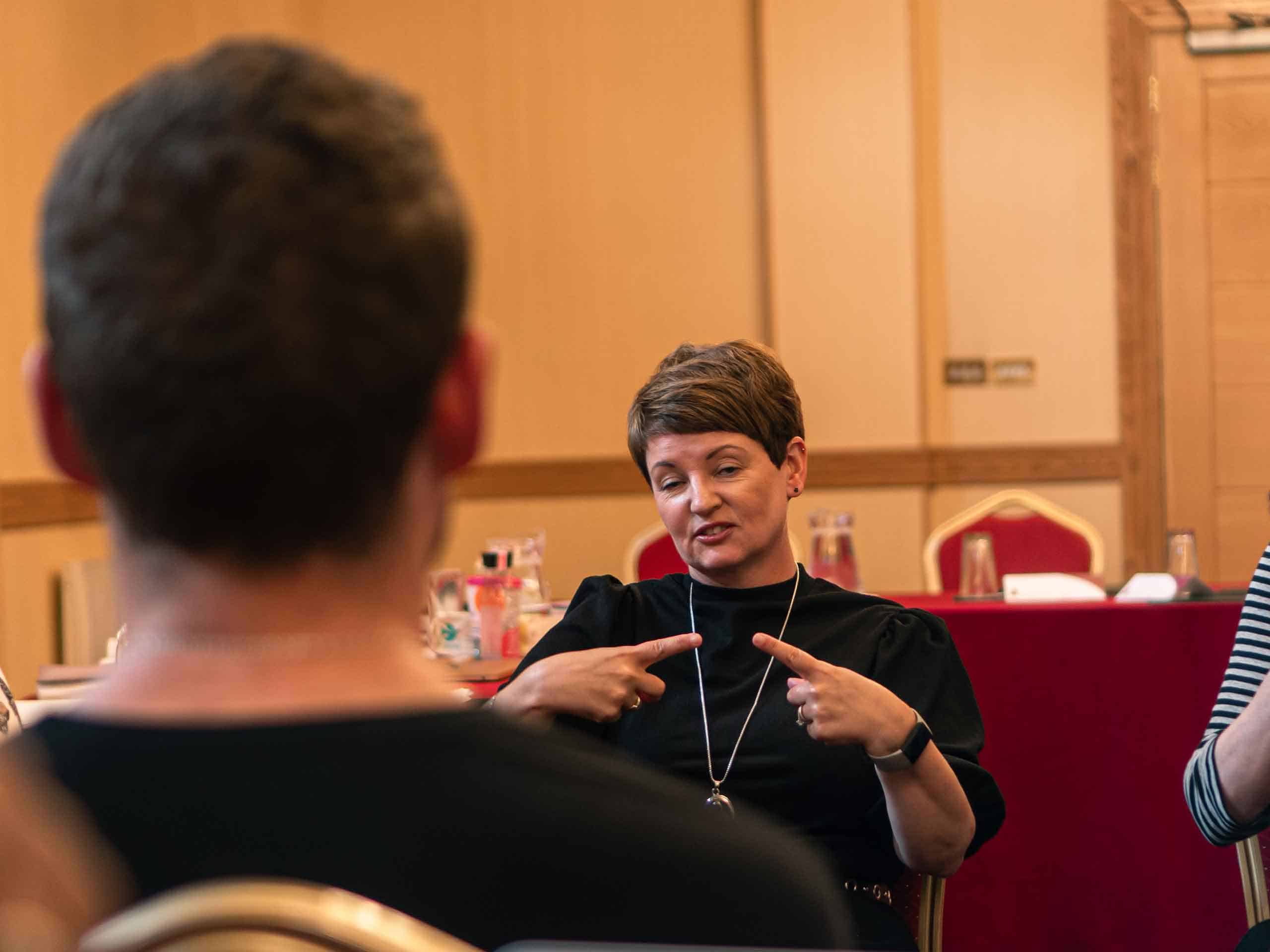 BSL Interpreter in front of a Deaf person